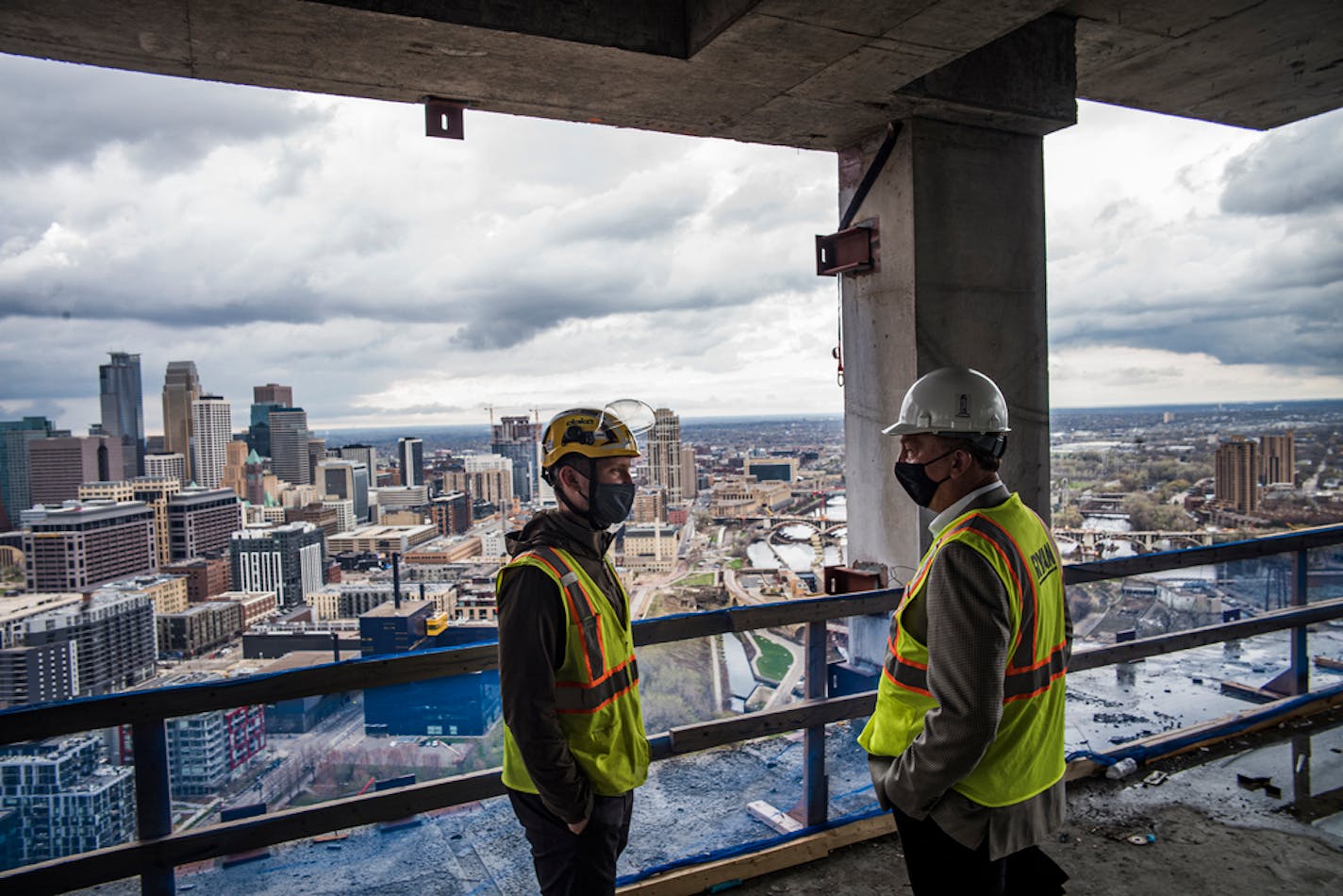 L to R Project manager Mitch Johnson, and Luigi Bernardi, CEO of Arcardia LLC and Kevin Mullen point out the quality construction and views as the reasons behind the premium prices for the condos.] A 42-story downtown Minneapolis condo tower (Eleven on the River) where prices start at just under $1 million has reached two milestones this week: Crews are pouring the top floor and about three quarters of the units now have buyers more than a year before the tower will be complete. RICHARD TSONG-TAATARII ¥ richard.tsong-taatarii@startribune.com