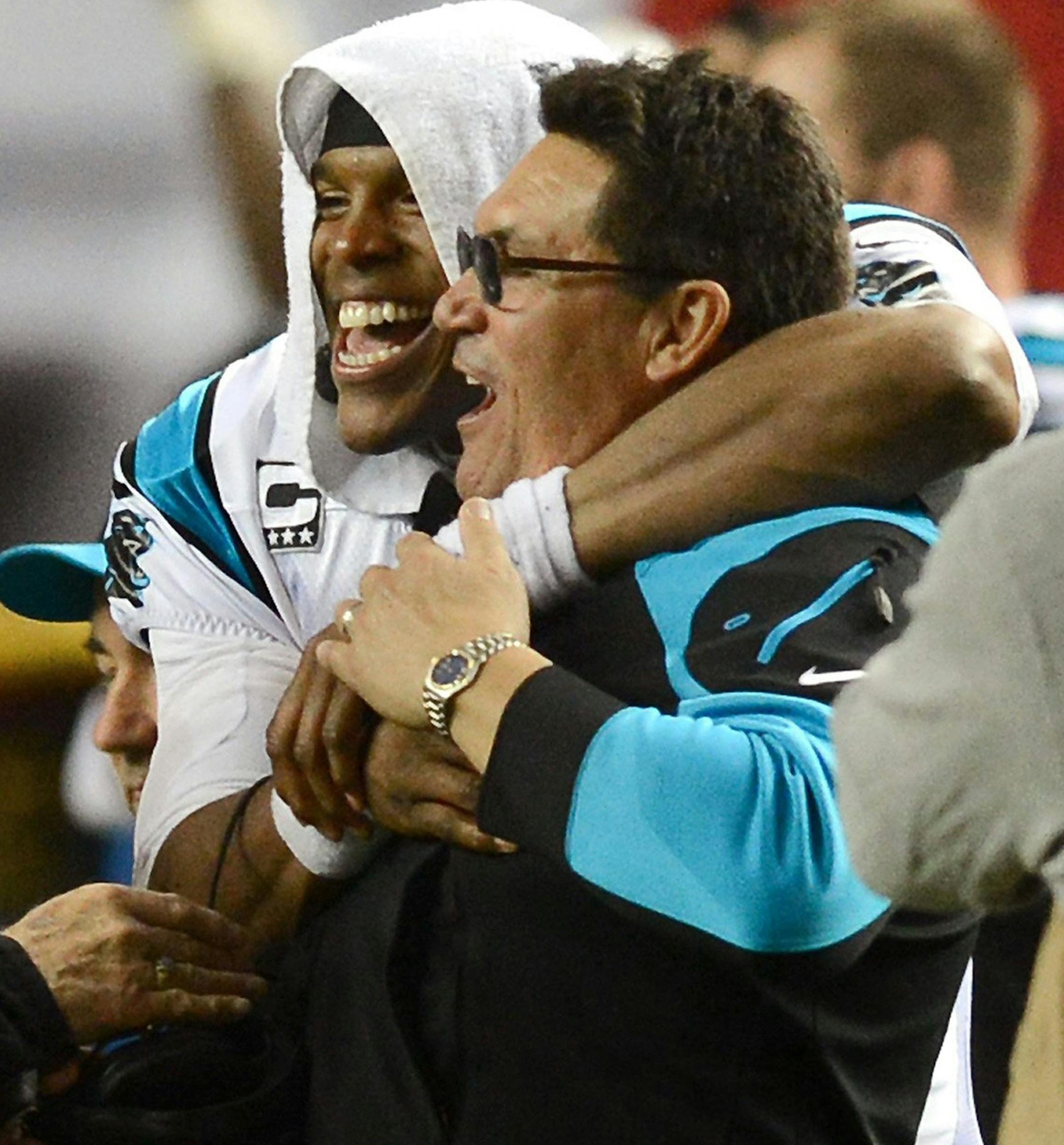 Carolina Panthers Gene Brown, left, quarterback Cam Newton (1) and head coach Ron Rivera celebrate a 21-20 victory over the Atlanta Falcons at the Georgia Dome in Atlanta, Sunday, Dec. 29, 2013. The Panthers won the NFC South with the victory. (Jeff Siner/Charlotte Observer/MCT)