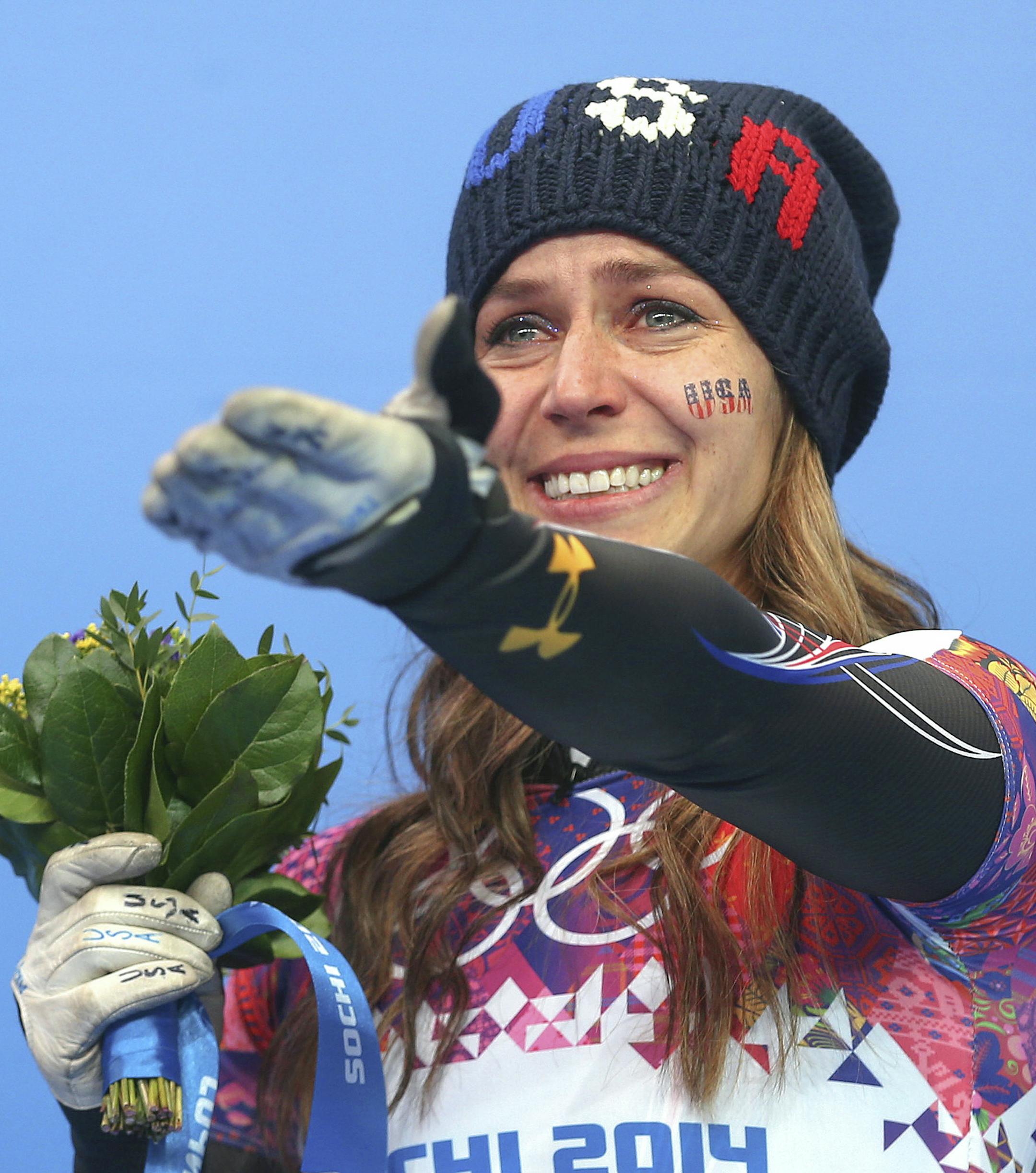 Silver medalist Noelle Pikus-Pace acknowledges friends in the crowd during the flowers ceremony after the women's skeleton event at the Sanki Sliding Center in Krasnaya Polyana, Russia, Feb. 14, 2014. Pikus-Pace finished behind only Elizabeth Yarnold of Great Britain. (Doug Mills/The New York Times)