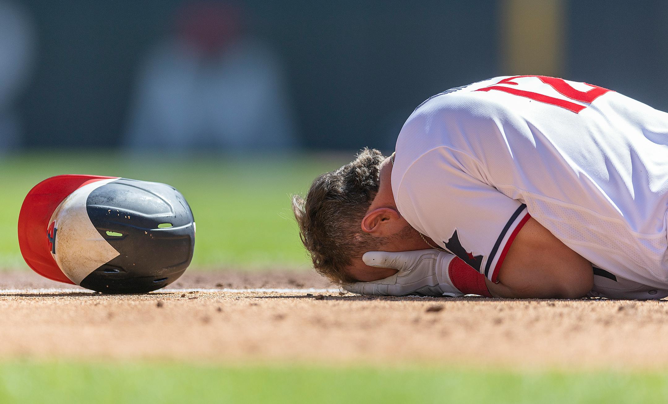 Minnesota Twins third baseman Kyle Farmer (12) falls to the ground after getting hit with a pitch during the bottom of the fourth inning.