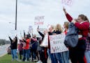 In April, demonstrators stood along Kenwood Trail during a rally before a school board meeting at the Lakeville District Office.