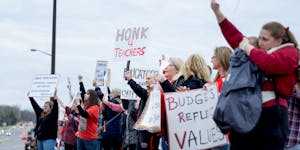 Demonstrators stood along Kenwood Trail during a rally before a school board meeting at the Lakeville District Office on Tuesday, April 30, 2024, in L