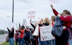 Demonstrators stood along Kenwood Trail during a rally before a school board meeting at the Lakeville District Office on Tuesday, April 30, 2024, in L