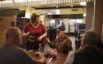 Tracy Bailey served coffee to a group of regulars shortly after her Bailey's Courtyard Cafe opened up for the day Thursday morning. The men, all retir
