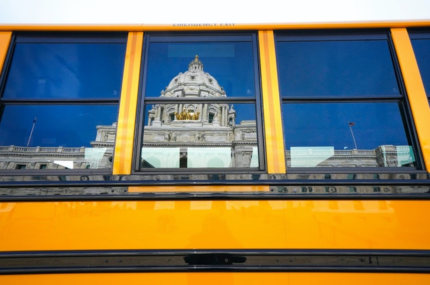 This file photo shows a school bus outside the Minnesota State Capitol in February 2020. More than 50 school board members in Minnesota have left their posts early during the past year. (Glen Stubbe/Star Tribune/TNS) ORG XMIT: 22472008W