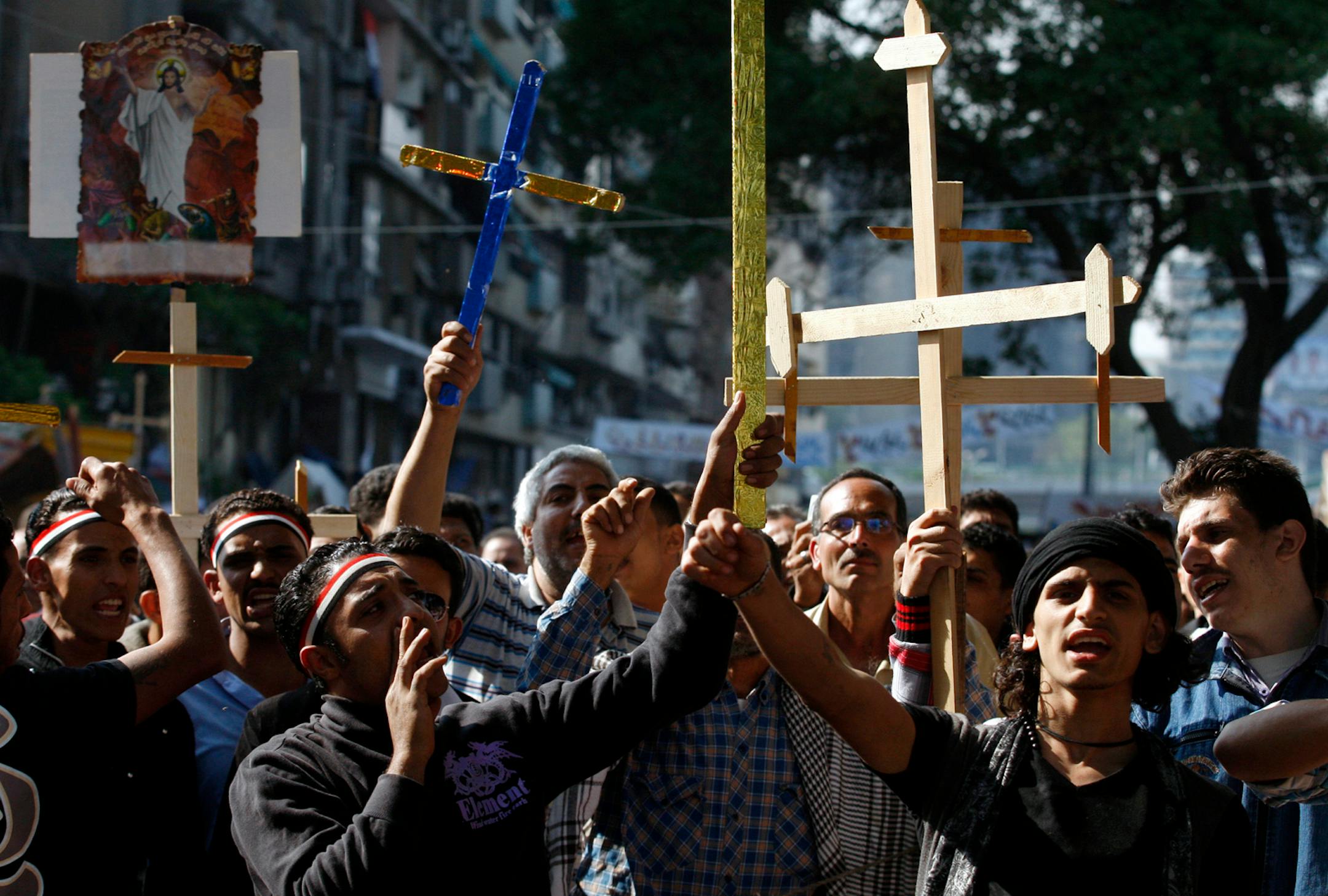 Egyptian Coptic Christians chant angry slogans as they protest recent attacks on Christians and churches, in front of the state television building in Cairo, Egypt, Sunday, May 15, 2011. An angry mob attacked a group of mainly Christian protesters demanding drastic measures to heal religious tension amid a spike in violence, leaving 65 people injured, officials said Sunday. (AP Photo/Khalil Hamra)
