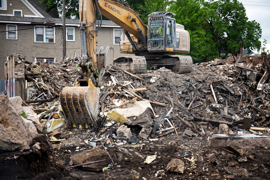 Construction crews remove rubble after the demolition of the Dundry House in Minneapolis on May 24.