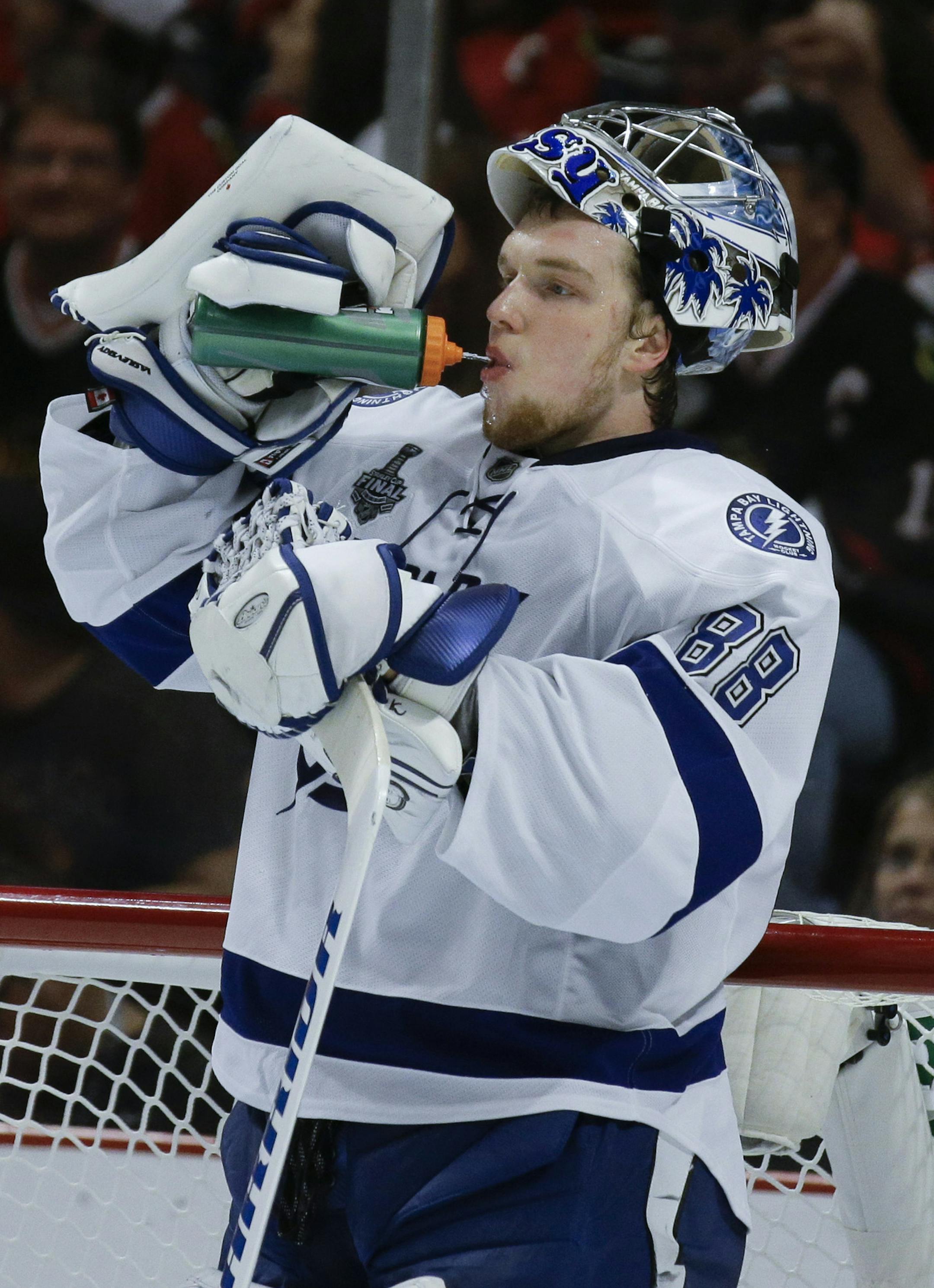 Tampa Bay Lightning goalie Andrei Vasilevskiy pauses during a timeout in the second period in Game 4 of the NHL hockey Stanley Cup Final against the Chicago Blackhawks Wednesday, June 10, 2015, in Chicago. (AP Photo/Nam Y. Huh)