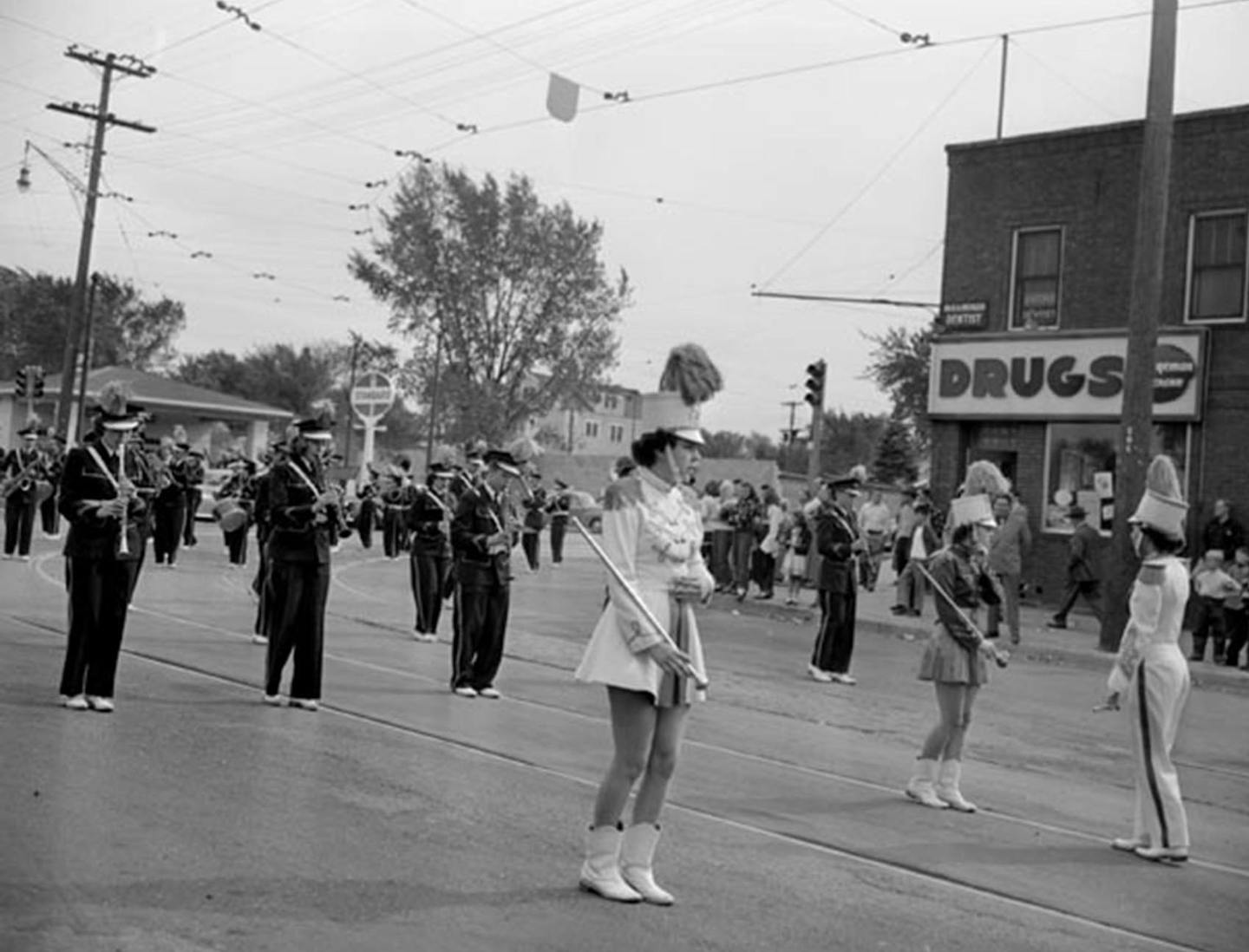 In September 1949, a drum major led a marching band down a parade route near the corner of Central Avenue and 40th Avenue NE. in Columbia Heights.