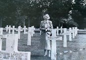 Mary McGowan at the grave of her brother Pvt. William Donnelley at an American cemetery in France.