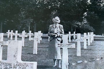 Mary McGowan at the grave of her brother Pvt. William Donnelley at an American cemetery in France.