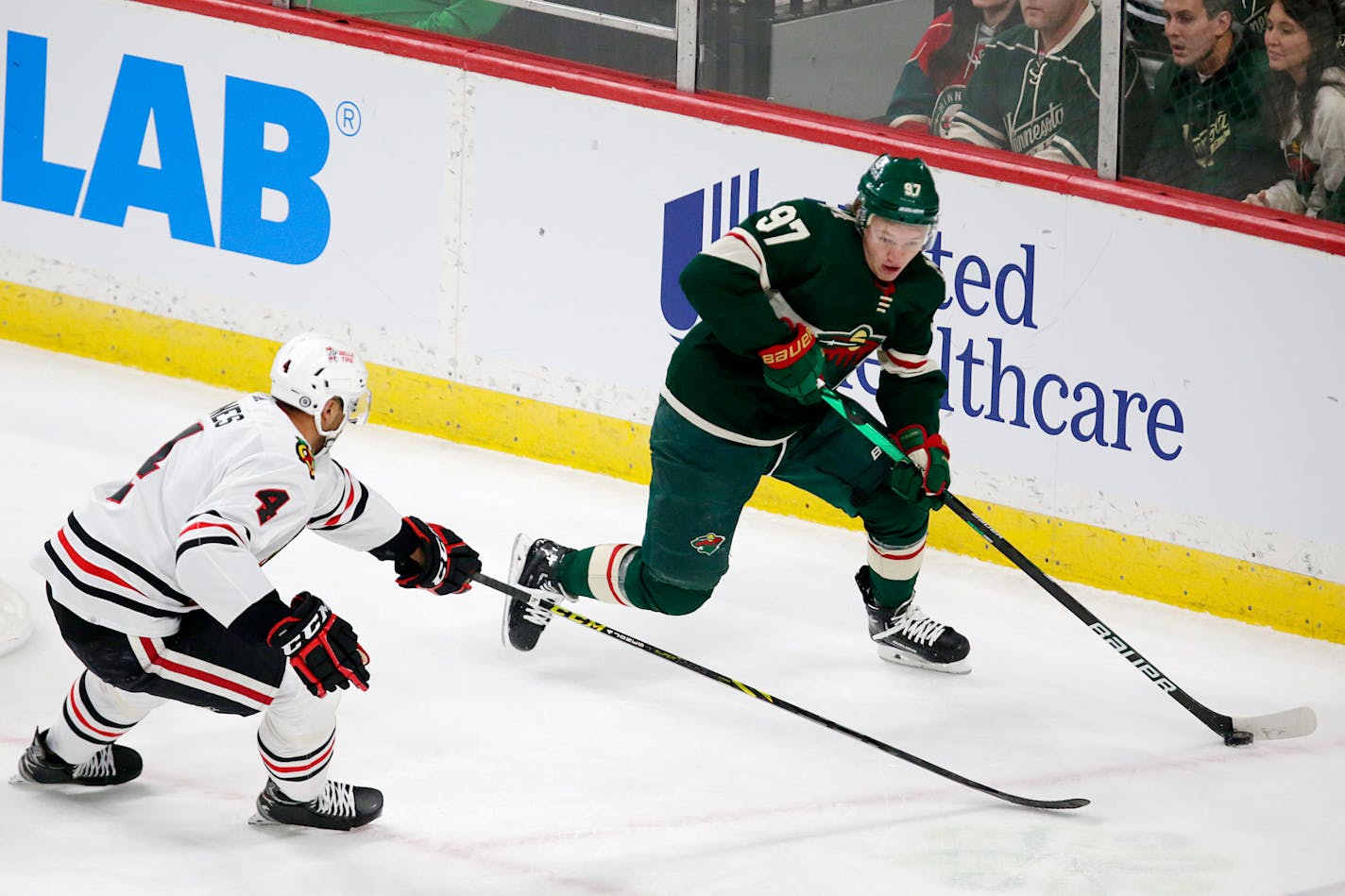 Wild left wing Kirill Kaprizov controls the puck in front of Chicago defenseman Seth Jones in the first period