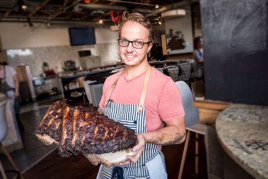 Minnesota Barbecue Company chef Kale Thome with a slab of ribs