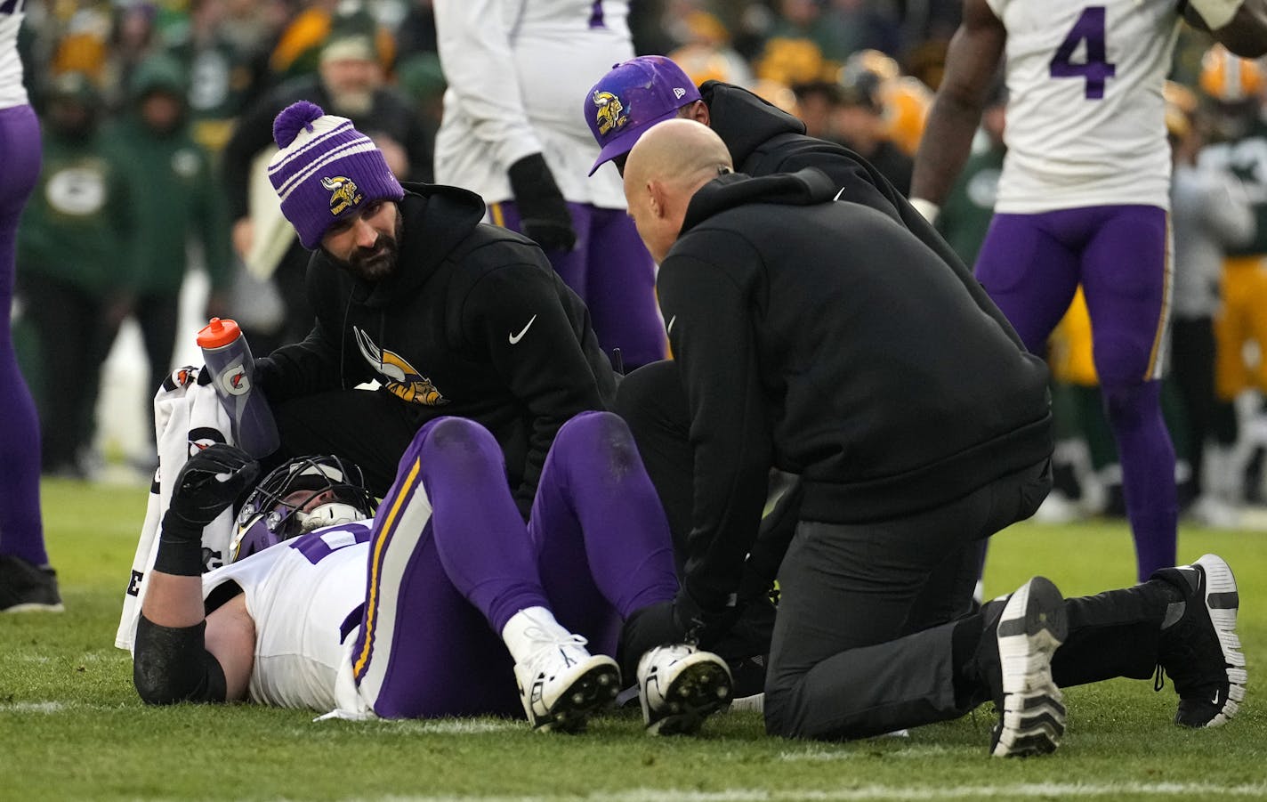 Vikings guard Austin Schlottmann is helped off the field after going down with an injury in the first quarter