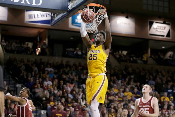 Daniel Oturu of the Gophers dunked during a game against Oklahoma earlier this season.