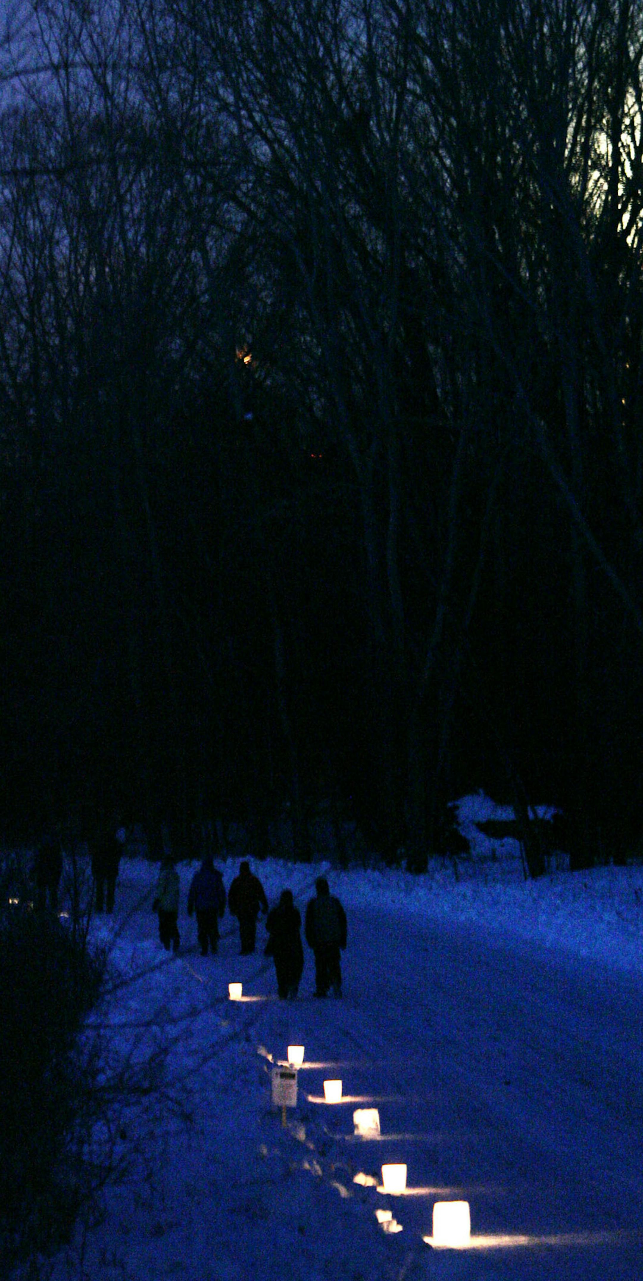 DAVID JOLES &#x2022; djoles@startribune.com Minneapolis, MN -Dec. 31, 2009-] Walkers with candles illuminating their way take part in a New Year's Eve walk at Fort Snelling State Park. Temps hovered around 0 degrees, but those taking part got a glimpse at a rare Blue Moon.