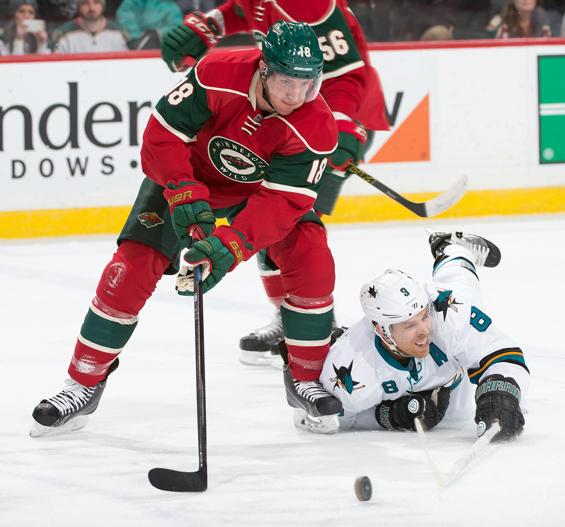 Minnesota Wild center Ryan Carter (18) chases down the puck as San Jose Sharks center Joe Pavelski (8) falls to the ice during the first period. ] (Aaron Lavinsky | StarTribune) The Minnesota Wild take on the San Jose Sharks Tuesday, Jan. 6, 2014 at Xcel Energy Center in St. Paul.