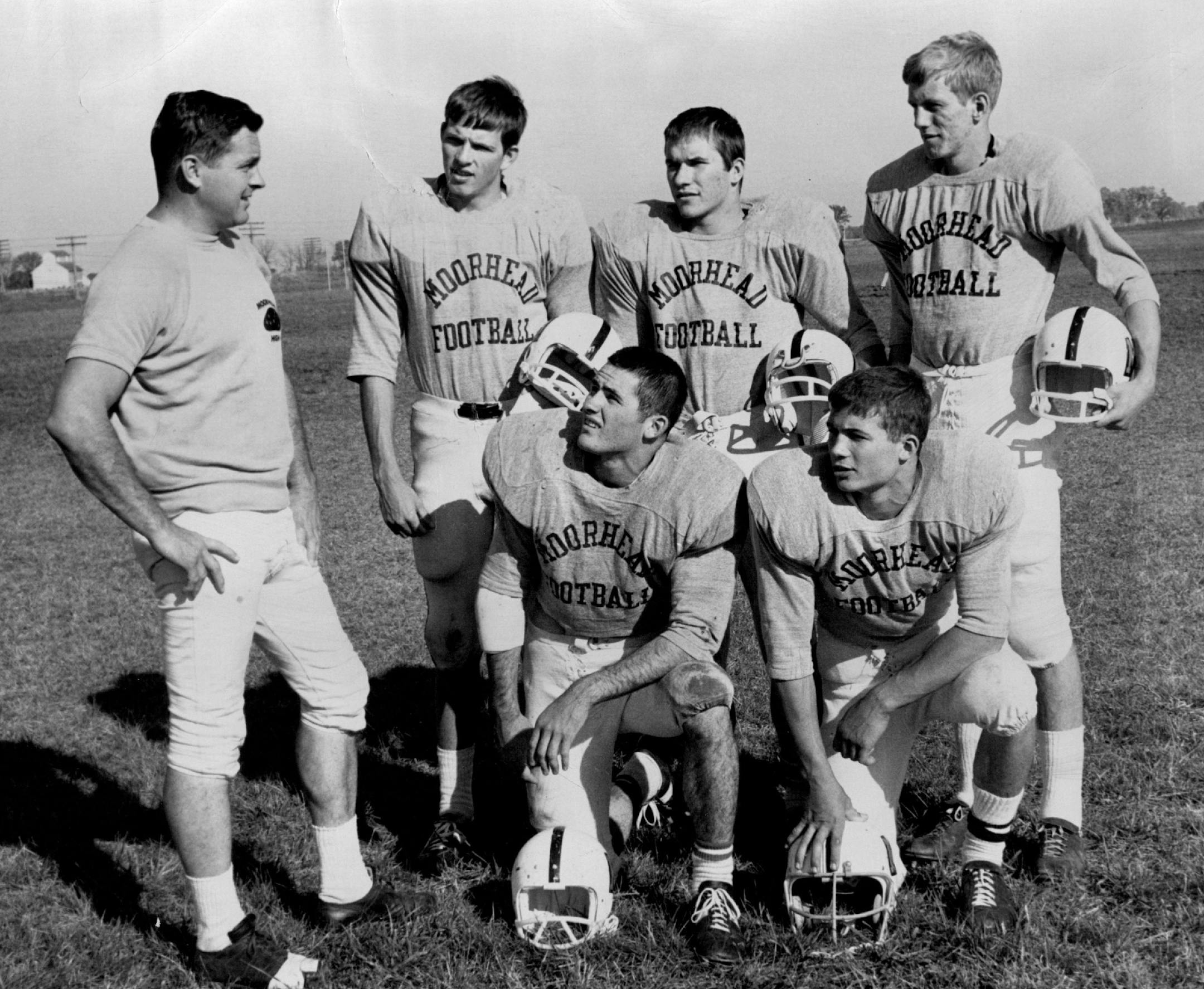 October 18, 1968: Coach Jim Gotta, looked over five of his Moorhead football players. They included (standing, from left) Paul Hanson, Dennis Kovash and Greg Troland and (kneeling, from left) Dale Powers and Mike Onderick.