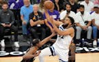 Wolves center Karl-Anthony Towns, right, drives to the basket against the Kevin Durant during the first half Sunday night in Phoenix.