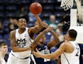 Michigan State forward Nick Ward (44) taps the ball away from Penn State guard Tony Carr (10) during the second half of an NCAA college basketball gam