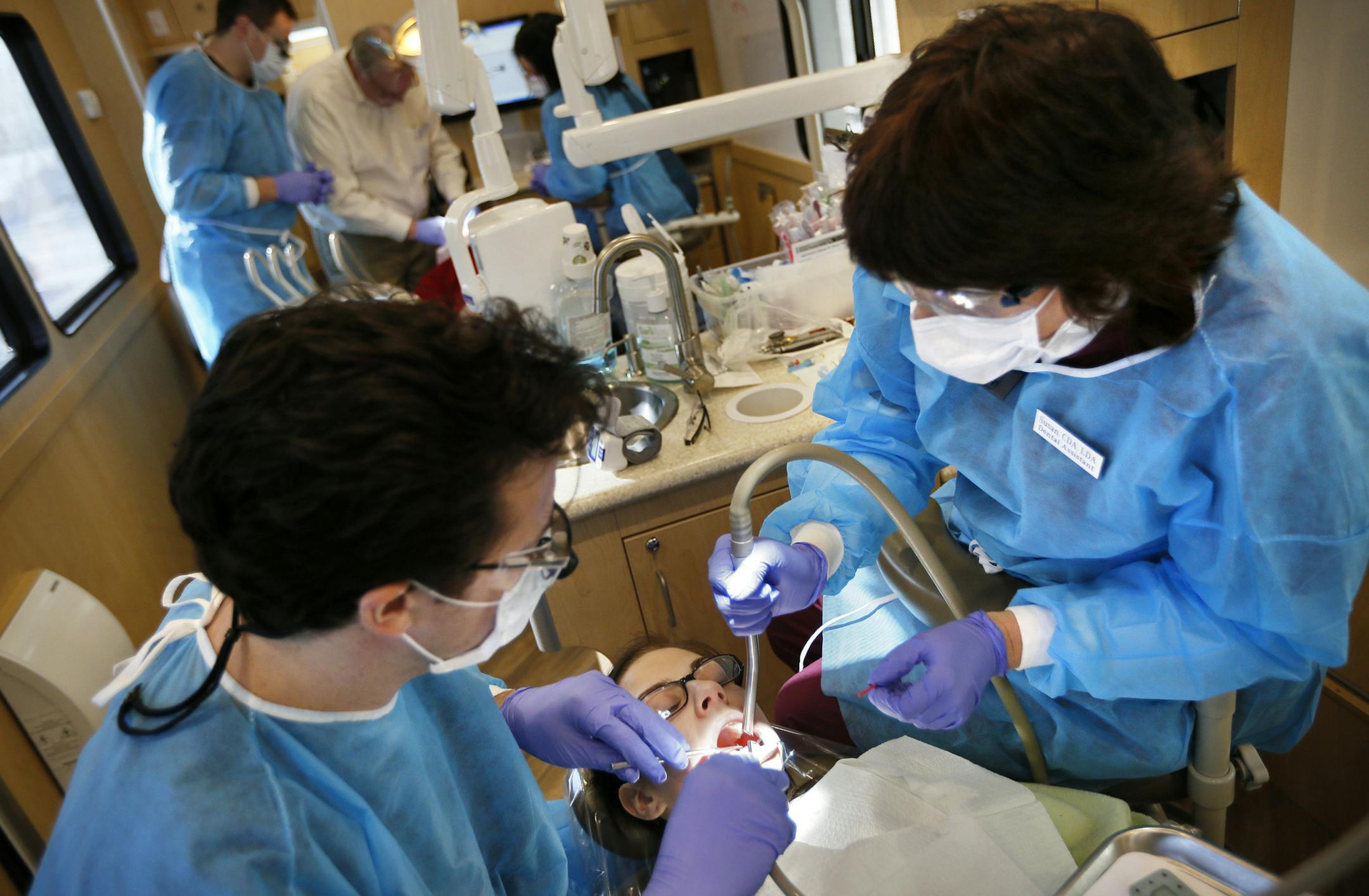 Parked outside Diamond Lake Lutheran Church in S. Minneapolis, children and adults receive dental care in the Ucare mobile dental clinic. The mobile clinic provides dental check-ups, cleanings, and simple restorative care to qualified eligible UCare members of all ages in Minnesota who have limited access to quality dental care. All care is provided by faculty-supervised dental and dental hygiene students from the University of Minnesota School of Dentistry, UCare's Mobile Dental Clinic partner.