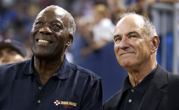 Former Twins' pitcher Jim "Mudcat" Grant, left, and second baseman Frank Quilici watch highlights of their 1965 World Series team on the scoreboard at