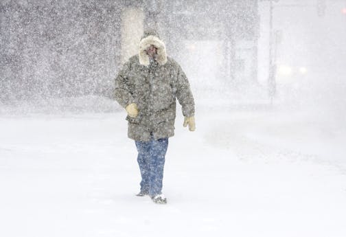 Dick Skogg of Duluth, Minn. walks down Superior Street toward the Lakewalk in Duluth on Sunday morning, Dec. 14, 2008. He walks five miles every day and didn't let the blizzard stop him from getting out the door. The Minnesota Transportation Department's Web site said blowing snow produced difficult driving conditions for most areas west and north of the Twin Cities. Many roads in western Minnesota closed.