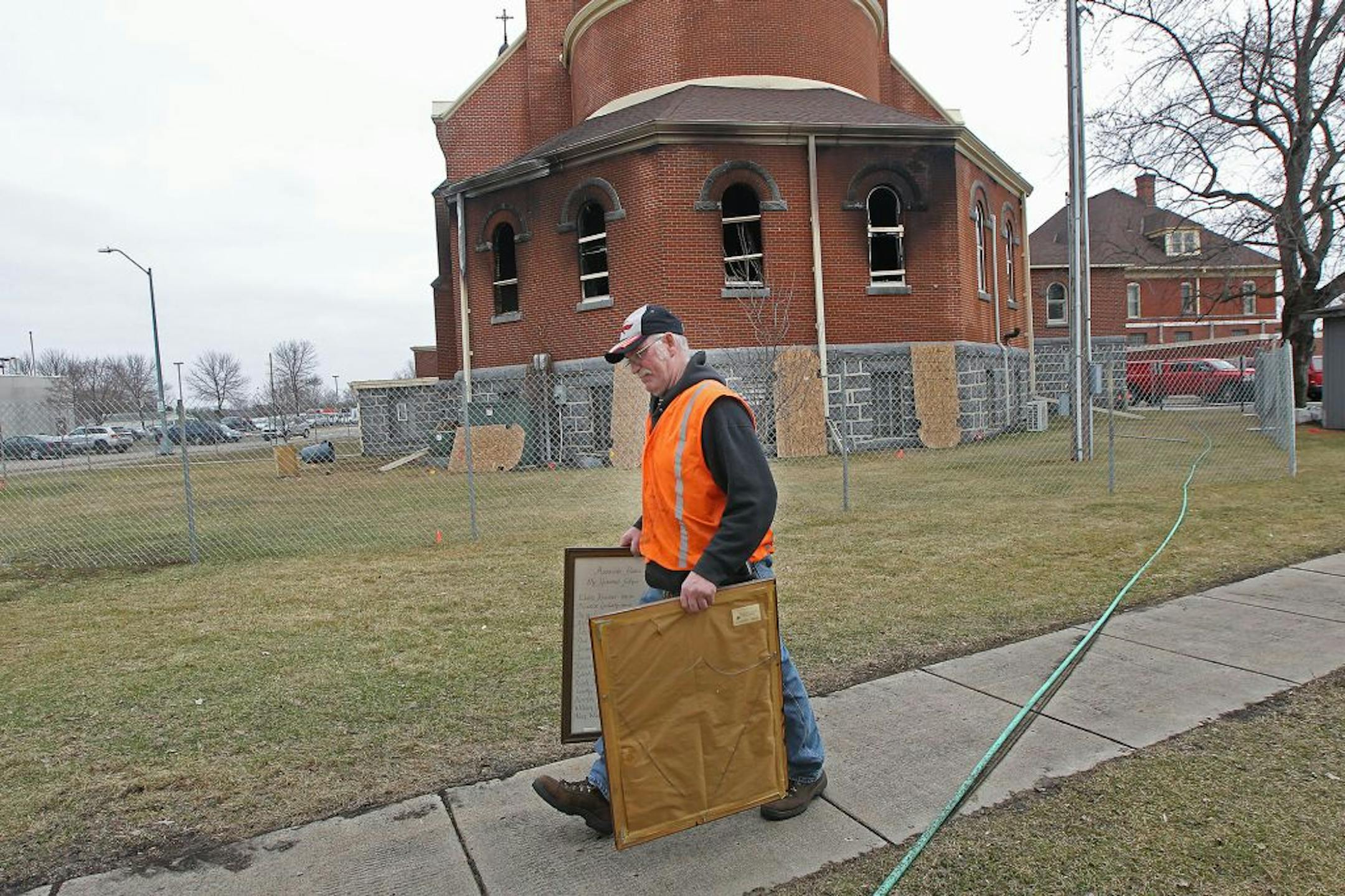 St. Mary's Catholic Church janitor Allan Wichmann, cq, tried to figure out where to place some historic frames that were recovered Friday, Monday, March 14, 2016 in Melrose, MN.