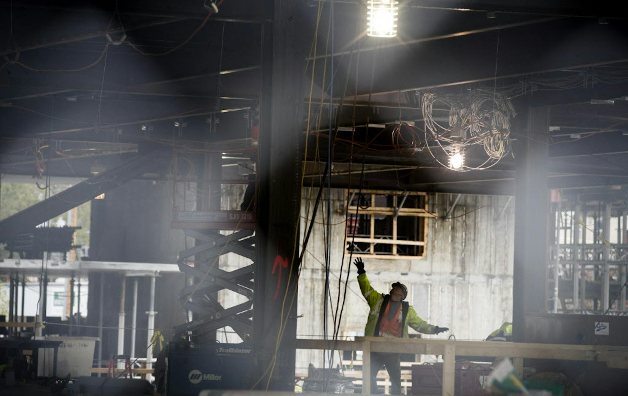 A construction workers works on the office part of a new mixed-use structure located at Portland Ave. and 9th Street in downtown Minneapolis. ] (Leila Navidi/Star Tribune) leila.navidi@startribune.com BACKGROUND INFORMATION: Construction on a new 17-story residential tower located at Portland Ave. and 9th Street in downtown Minneapolis on Wednesday, October 26, 2016. The 306-unit apartment residence has been named “H.Q.” Owned by Kraus-Anderson, H.Q. is part of the new comprehensiv