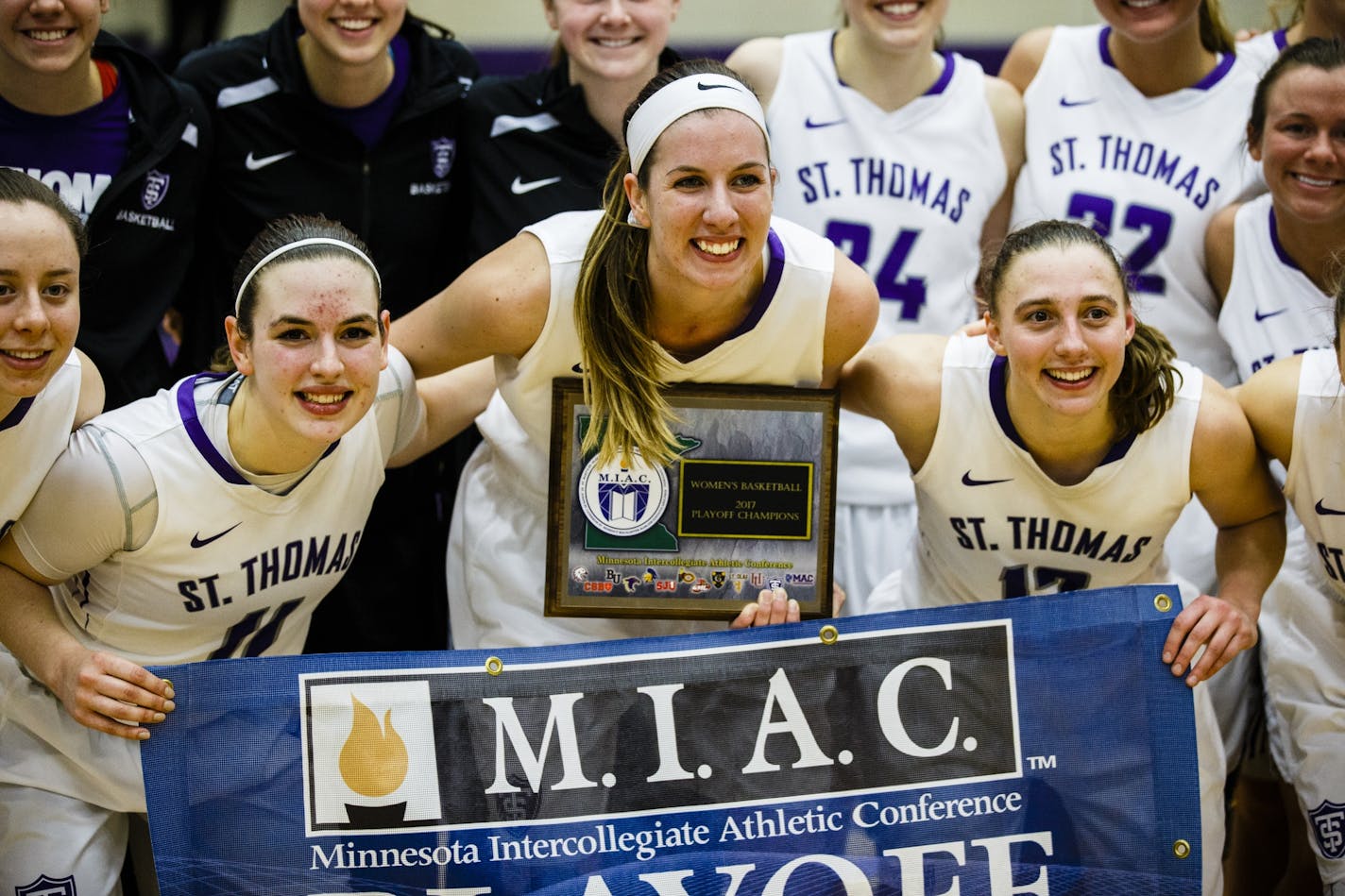 From left: Maddie Wolkow, Kaitlin Langer and Paige Gernes pose with the MIAC Championship trophy and banner following the women's basketball MIAC Championship game versus Gustavus Adolphus College February 26, 2017 in Schoenecker Arena. The Tommies beat the Knights 66-49.