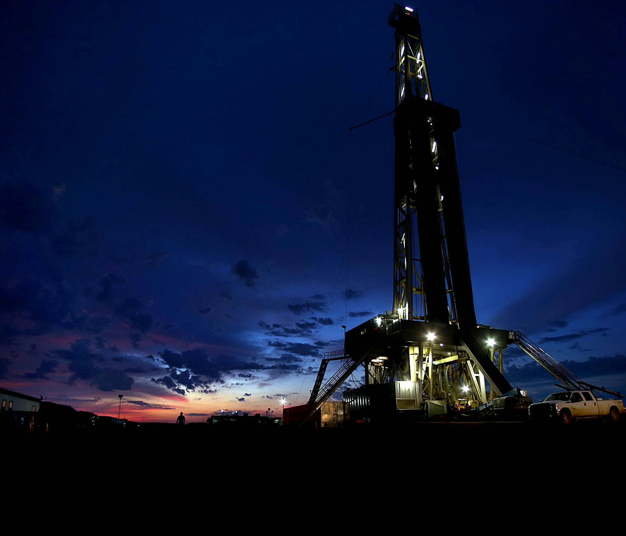 Dozens of drilling rigs dot the North Dakota landscape in the Williston Basin and the Bakken Oil Formation. Once the rigs drill holes, several miles deep and then several miles horizontally, hydraulic fracturing technology (‚Äúfracking‚Äù) is then employed to extract oil and natural gas from the underlying shale formation. Workers at this rig, Raven Drilling Rig #1, located near Watford City, toil around the clock to drill holes along a prescribed route. ] (JIM