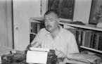 Ernest Hemingway sitting at typewriter, writing on “Finca Vigia, near San Francisco de Paula, Cuba 