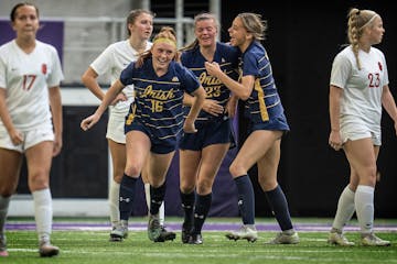 Rosemont's Shay Payne, (23) celebrates her second half goal with teammates.