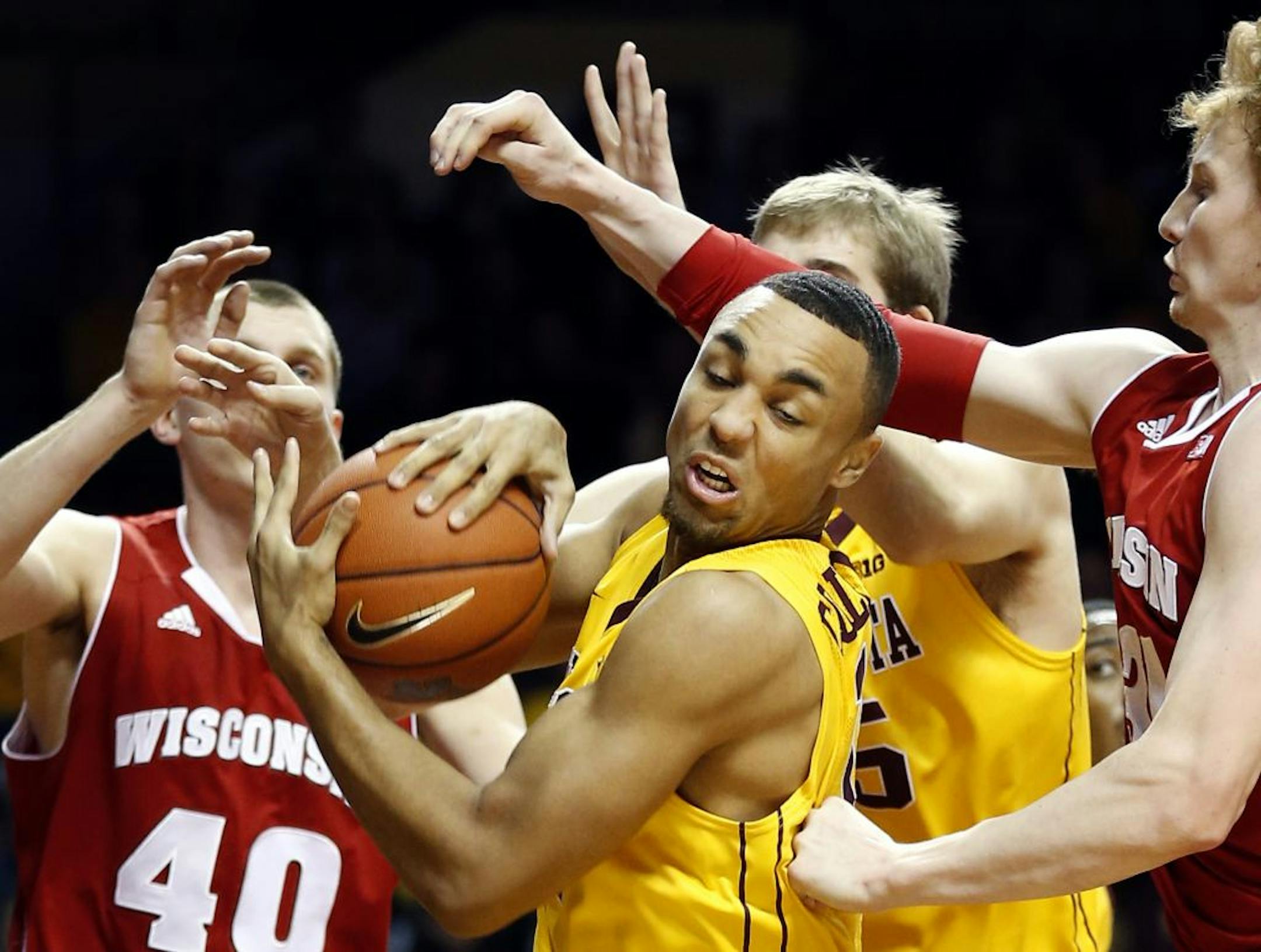 Gophers guard Joe Coleman (11) grabbed a rebound against Wisconsin.