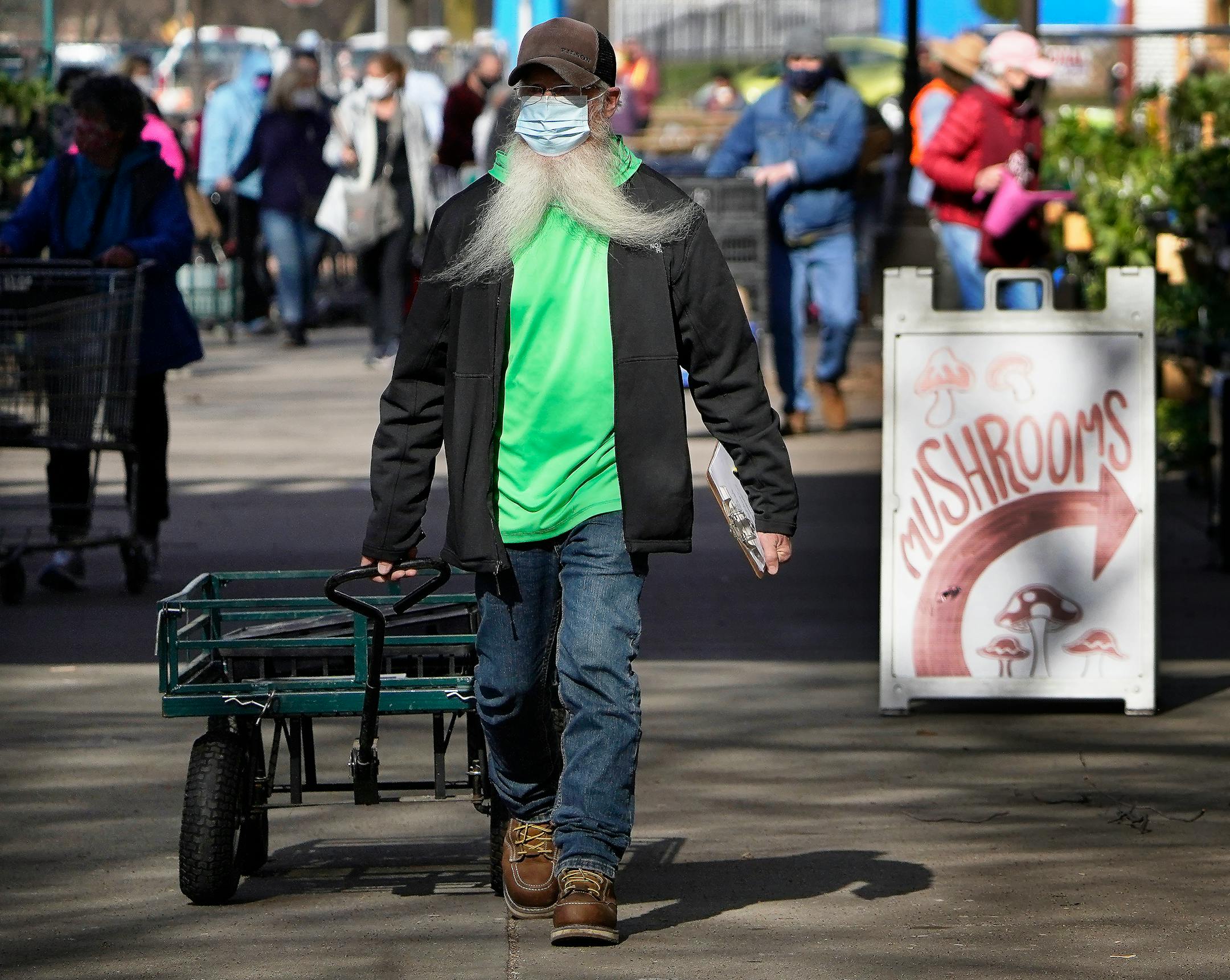 Wind splits the beard into a seeming mustache of a man who wished not to give his name who was among many shopping for plants at the Friends School of Minnesota fundraiser plant sale.