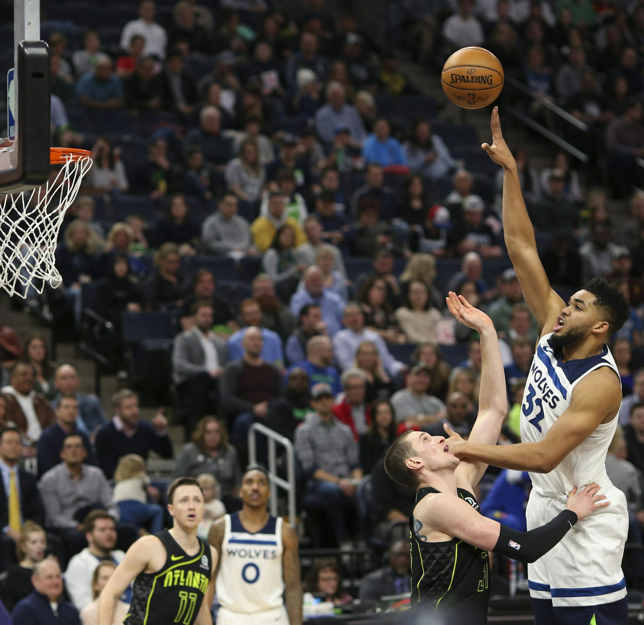 Minnesota Timberwolves center Karl-Anthony Towns (32) launched a first half shot for a basket over Atlanta Hawks forward Mike Muscala (31) on a night that saw him scoring a franchise-record 56 points. ] JEFF WHEELER ï jeff.wheeler@startribune.com The Minnesota Timberwolves beat the Atlanta Hawks 126-114 in an NBA basketball game Wednesday night, March 28, 2018 at Target Center in Minneapolis.