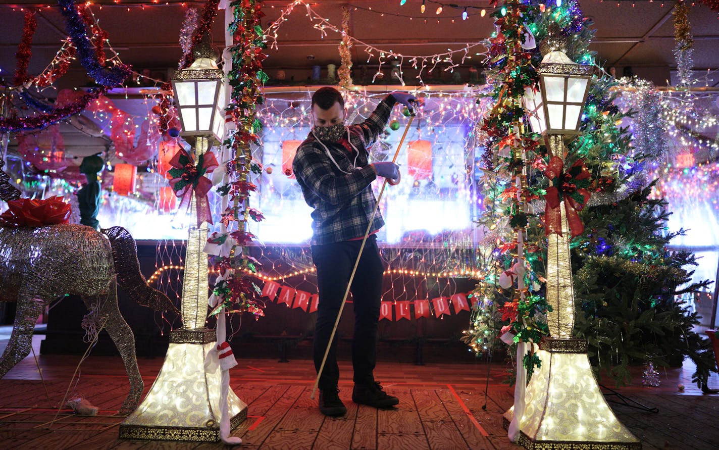 The transformation of Psycho Suzi's into Mary's Christmas Palace, an over-the-top holiday-themed bar in North East Minneapolis. Here, James Area, measures the space for another installation. brian.peterson@startribune.com Minneapolis, MN Wednesday, September 30, 2020