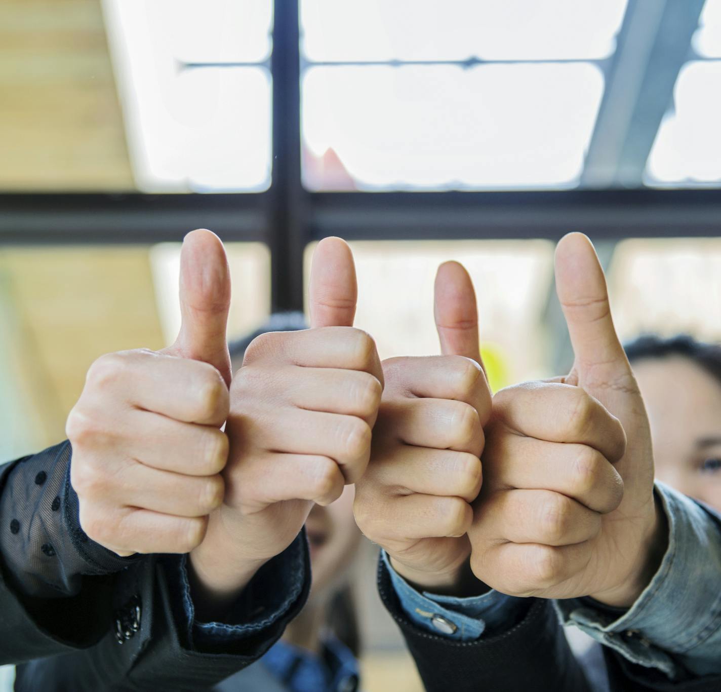 Business people showing thumb's up