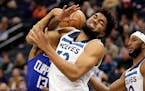 Minnesota Timberwolves center Karl-Anthony Towns (32) is fouled by Los Angeles Clippers guard Paul George (13) during the first half of an NBA basketb