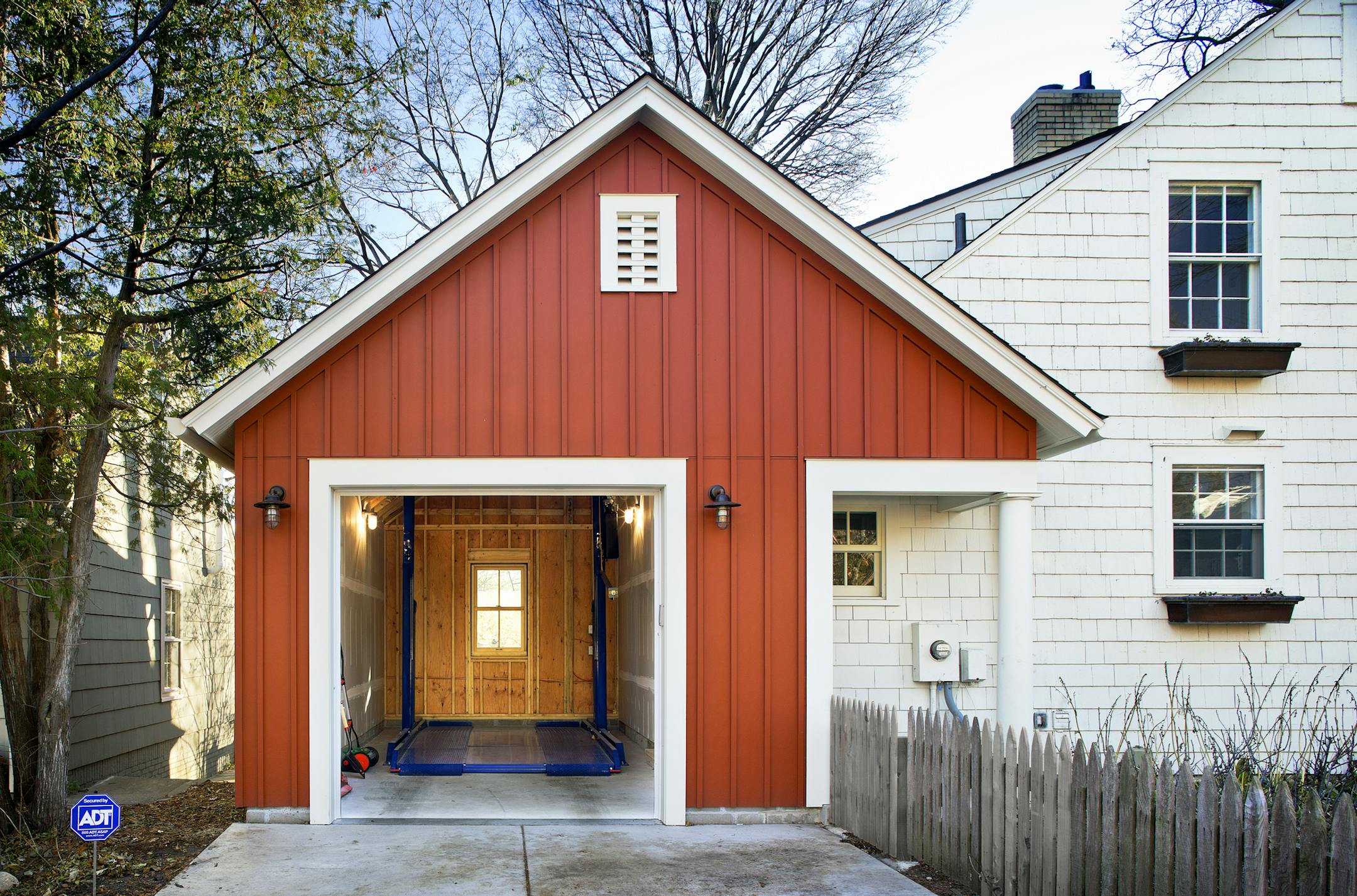 A new garage, built up instead of out, houses two cars on a small city lot.