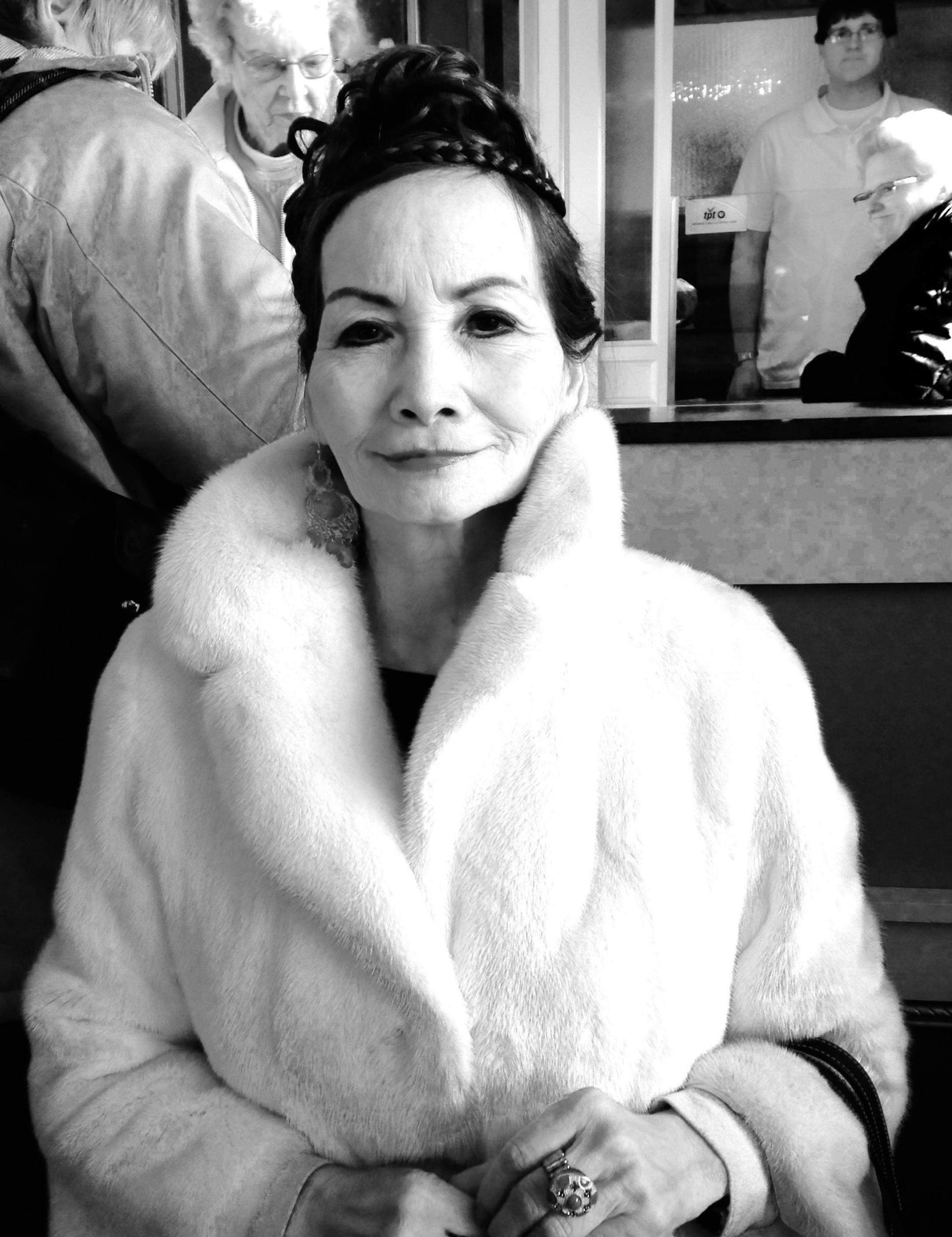 Woman dressed as Audrey Hepburn at screening of "Breakfast at Tiffany's"