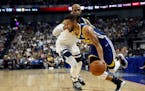 Warriors guard Stephen Curry drove past the Timberwolves' Taj Gibson during their preseason NBA game in Shanghai, China, on Sunday.