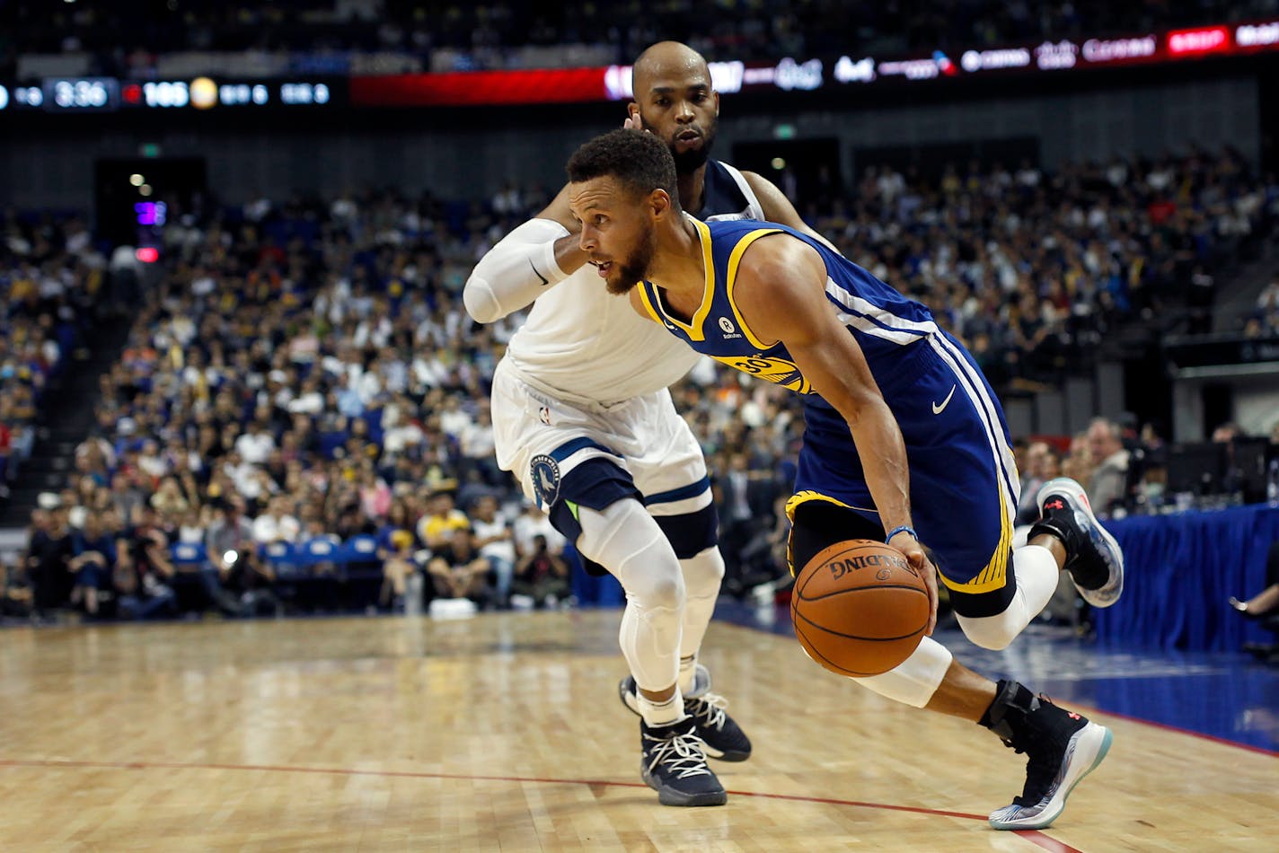 Warriors guard Stephen Curry drove past the Timberwolves' Taj Gibson during their preseason NBA game in Shanghai, China, on Sunday.