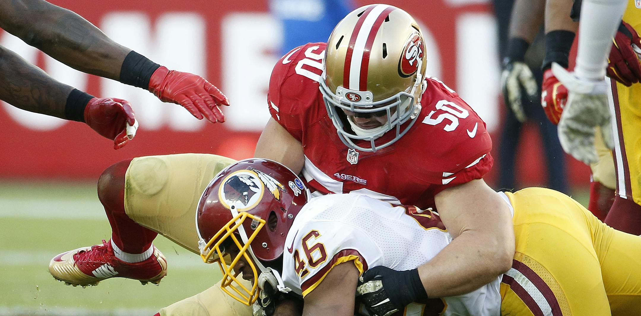 FILE - In this Sunday, Nov. 23, 2014, file photo, San Francisco 49ers inside linebacker Chris Borland (50) tackles Washington Redskins running back Alfred Morris (46) during the second half of an NFL football game in Santa Clara, Calif. The 49ers announced late Monday, March 16, 2015, that Borland is retiring after one season, without offering specifics. (AP Photo/Tony Avelar, File)