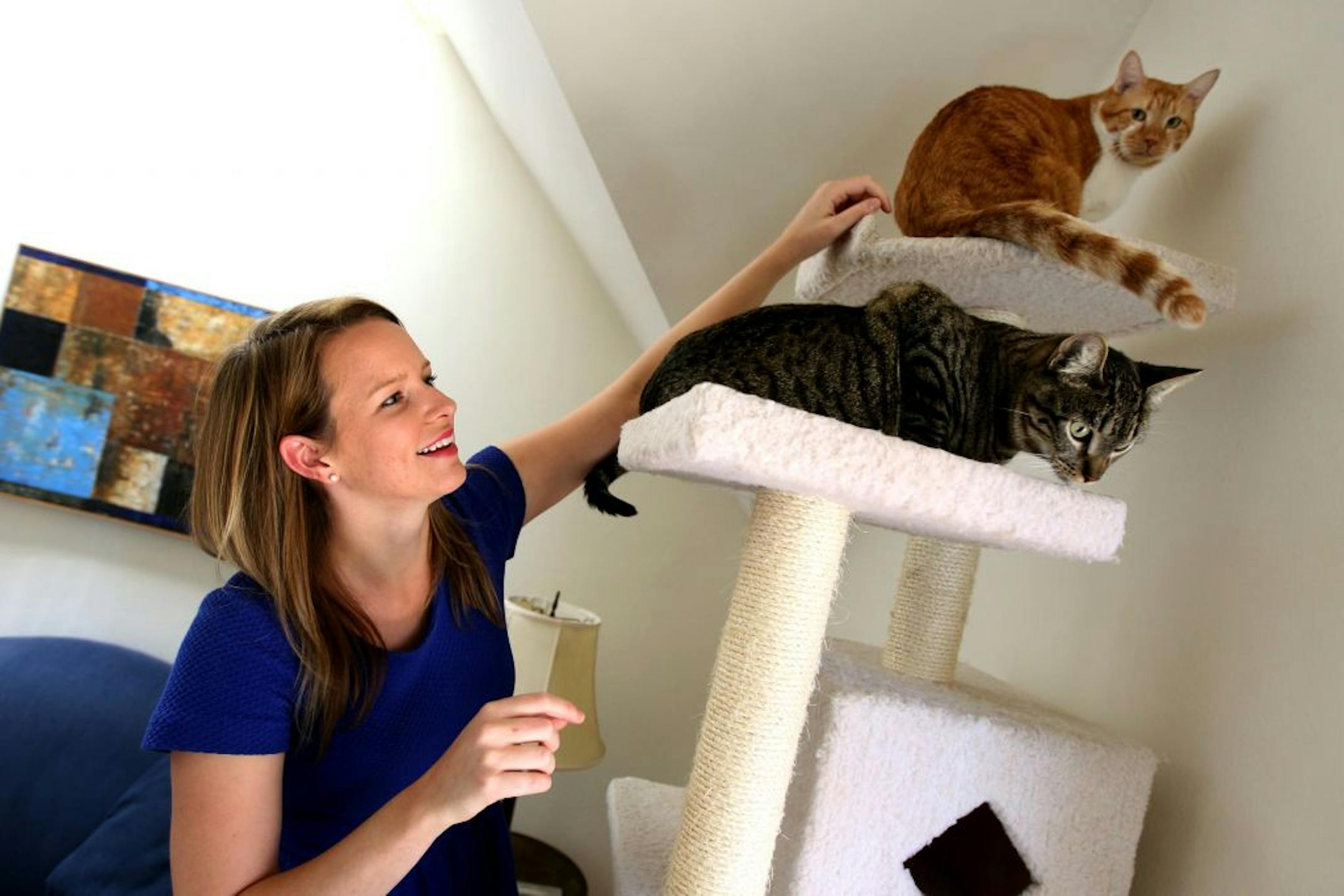 Katie Hill with her two cats Ron (brown) and Max (gray) at her home.