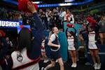 UConn players, including guard Paige Bueckers (5), arrive for a Final Four open practice held Saturday, April 2, 2022 at Target Center in Minneapolis,