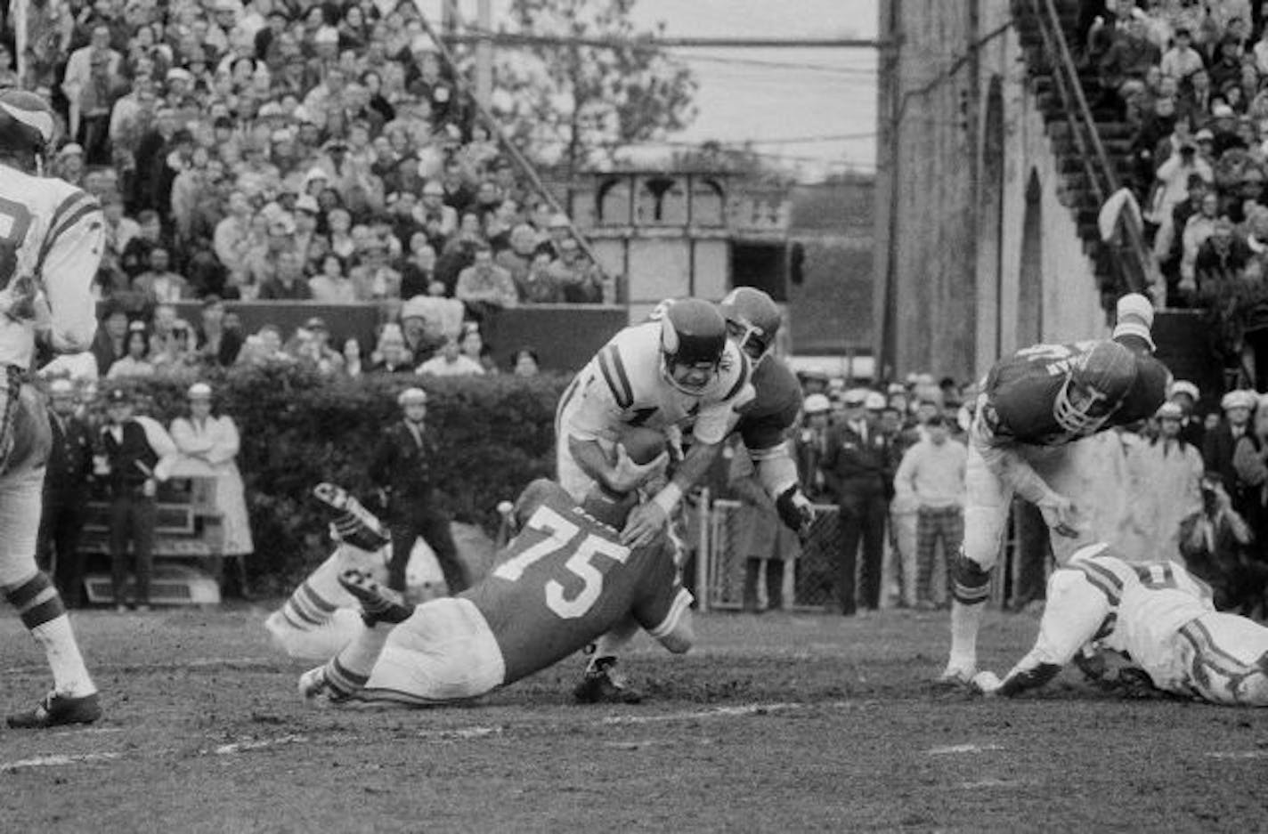 Minnesota Viking quarterback Joe Kapp is hauled down by Kansas City Chiefs Jerry Mays (75) as another Chief moves in from the rear during the first half of Super Bowl IV, Jan. 11, 1970, in New Orleans.