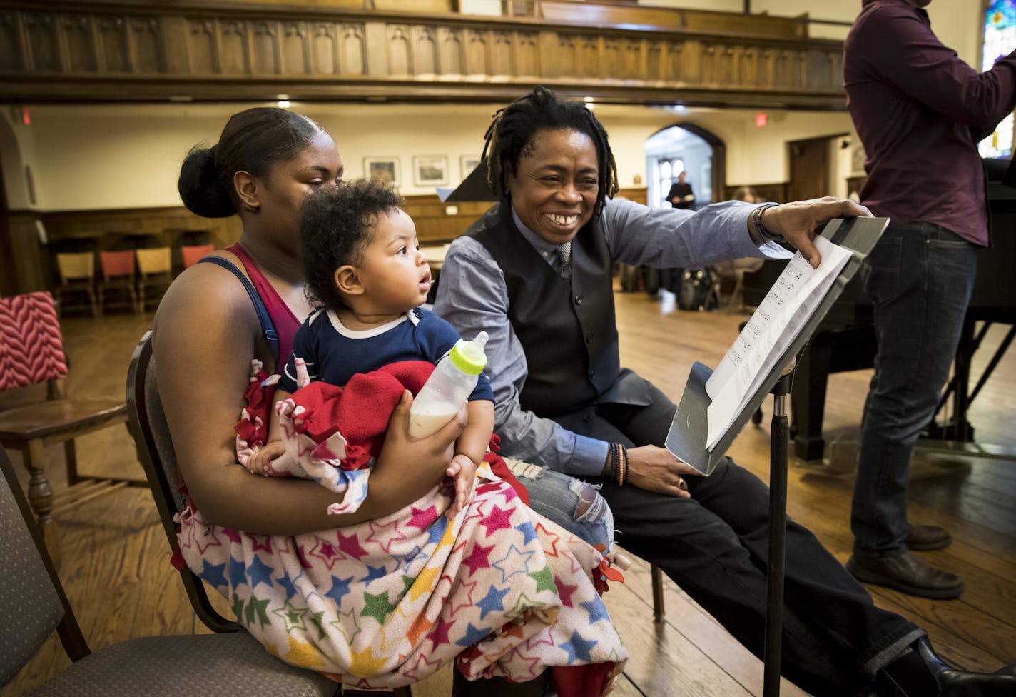 Guest artist Melanie DeMore pointed to the music as Amina Caver sat on her mother Arianna Caver's lap listening to a song for the first time Arianna had wrote for her as park of the Lullaby project at Plymouth Congressional Church on Tuesday, January 10, 2016, in Minneapolis, Minn. ] RENEE JONES SCHNEIDER &#x2022; renee.jones@startribune.com