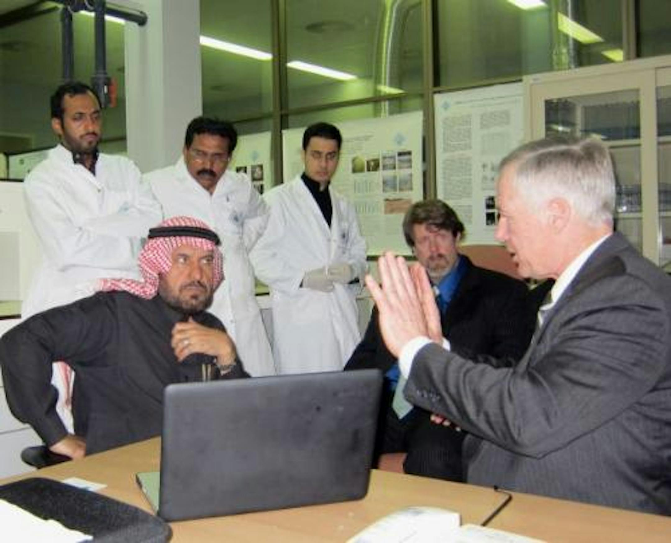 Three scientists stood behind Dr. Nassar Al-Khalifah, left foreground, and Thomas Johnson as they listened to Dennis Zeug describe Fresh EcoHarvest's technology. Photo provided by the BioBusiness Alliance of Minnesota.