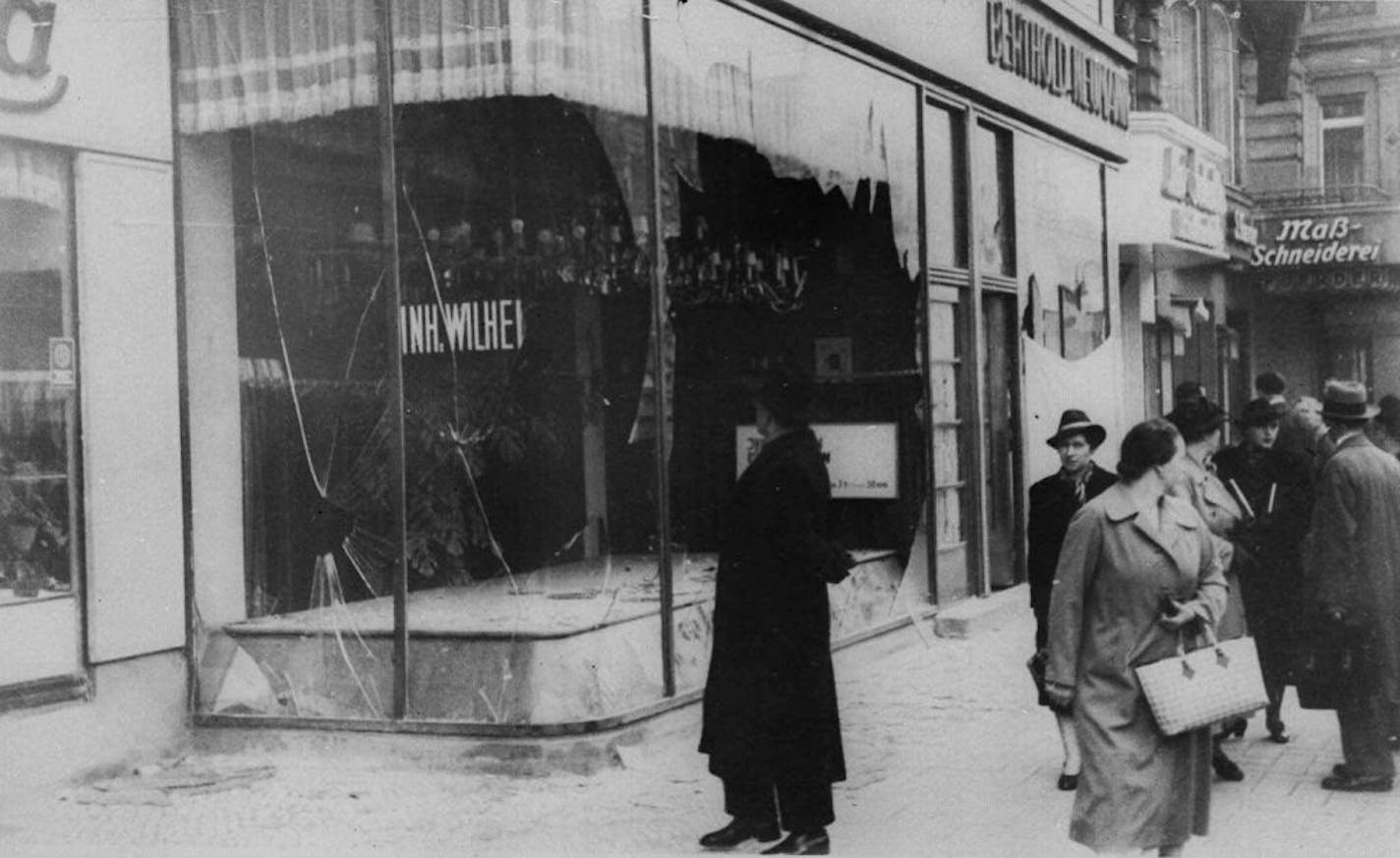 A pedestrian looks at the wreckage of a Jewish shop in Berlin, Nov. 10, 1938, the day after the "Kristallnacht" rampage, when Nazi thugs set fire to hundreds of synagogues, looted thousands of Jewish businesses and attacked Jews in Germany and Austria. Germany's remembrance of the Nov. 9, 1938 terror, the ``Night of Broken Glass,'' comes amid fresh debate on the nation's relationship with its past--triggered by the government's return to Berlin, the prewar capital from which Adolf Hitler ruled.